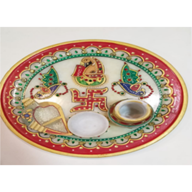 Marble puja thali with three articles.